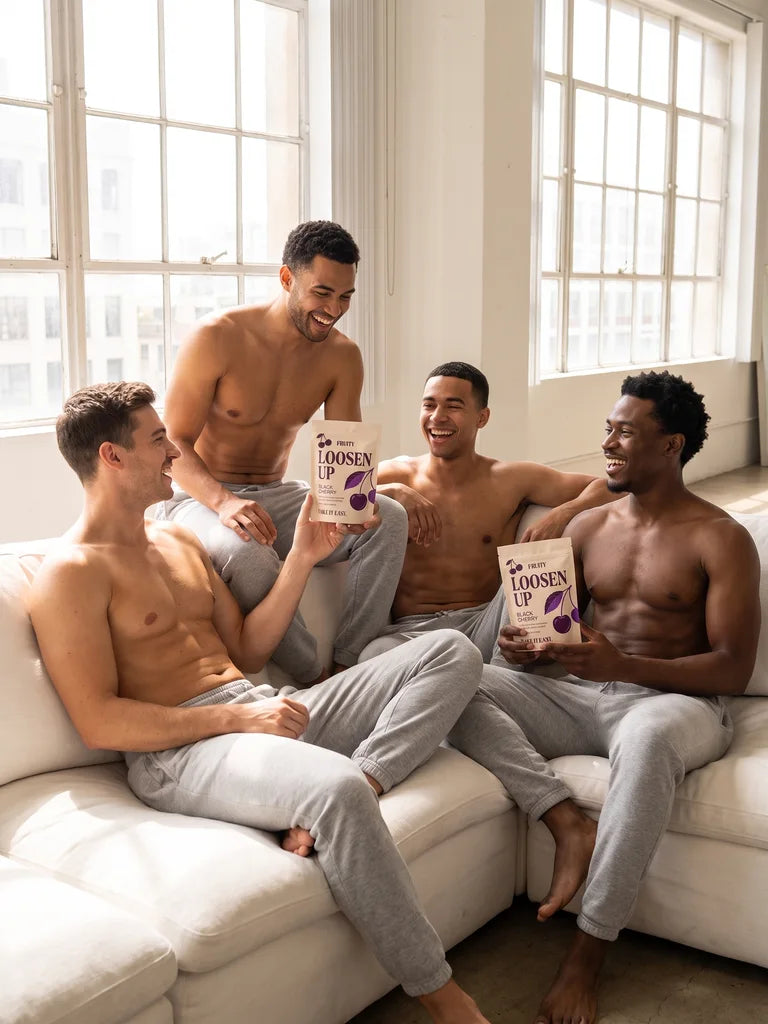 Four friends laughing on a sofa holding Loosen Up pouches