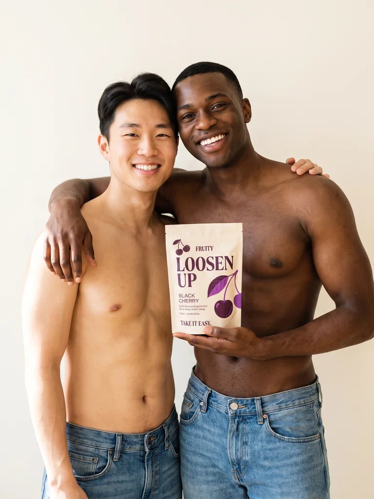 A smiling couple holding a Loosen Up pouch
